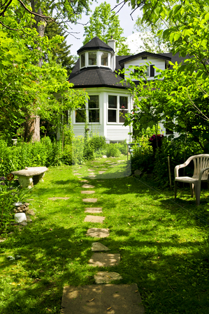 To use this stock image in your creative project, please select the size you need over to the right and click the "Add to Cart" button.
Your downloaded image will come with the Cutcaster watermark removed so don’t worry about the watermark you see on this page. Home and garden stock photo, Path of steeping stones leading to a house in lush green garden by Elena Elisseeva