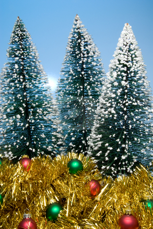 To use this stock image in your creative project, please select the size you need over to the right and click the "Add to Cart" button.
Your downloaded image will come with the Cutcaster watermark removed so don’t worry about the watermark you see on this page. Christmas Trees stock photo, Christmas trees covered in snow surrounded by garland and ornaments. by Robert Byron