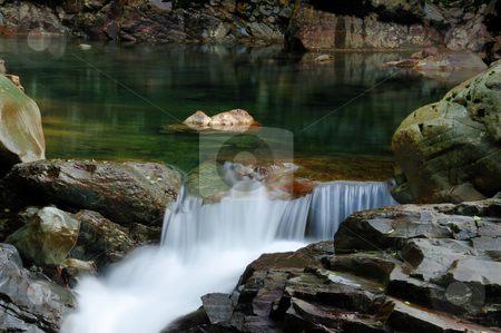 To use this stock image in your creative project, please select the size you need over to the right and click the "Add to Cart" button.
Your downloaded image will come with the Cutcaster watermark removed so don’t worry about the watermark you see on this page. Wild stream flowing through rocks stock photo, Wild stream flowing through rocky river bed by Nilanjan Bhattacharya