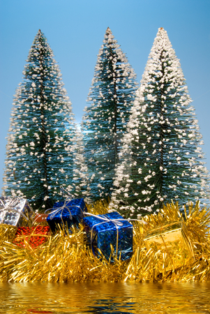 To use this stock image in your creative project, please select the size you need over to the right and click the "Add to Cart" button.
Your downloaded image will come with the Cutcaster watermark removed so don’t worry about the watermark you see on this page. Christmas Lake stock photo, Christmas presents under pine trees by a lake. by Robert Byron