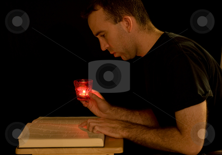 To use this stock image in your creative project, please select the size you need over to the right and click the "Add to Cart" button.
Your downloaded image will come with the Cutcaster watermark removed so don’t worry about the watermark you see on this page. Reading By Candlelight stock photo, A young man trying to read a book in the dark by Richard Nelson