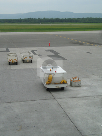 To use this stock image in your creative project, please select the size you need over to the right and click the "Add to Cart" button.
Your downloaded image will come with the Cutcaster watermark removed so don’t worry about the watermark you see on this page. Empty airplane gate with small trucks stock photo, by Mbudley Mbudley