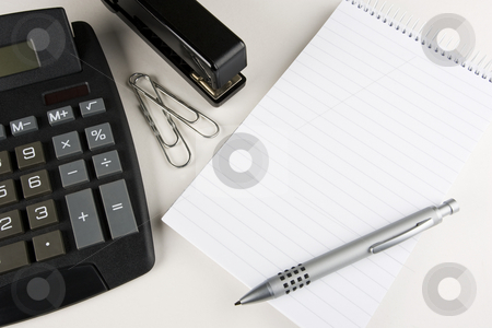 To use this stock image in your creative project, please select the size you need over to the right and click the "Add to Cart" button.
Your downloaded image will come with the Cutcaster watermark removed so don’t worry about the watermark you see on this page. Office Scene stock photo, A desktop calculator, stapler and paper clips stands next to a blank writing pad with a stylish pen atop by Steve Smith