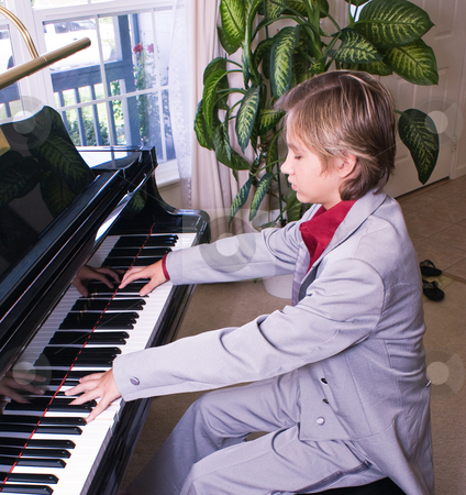 To use this stock image in your creative project, please select the size you need over to the right and click the "Add to Cart" button.
Your downloaded image will come with the Cutcaster watermark removed so don’t worry about the watermark you see on this page. Young man preparing for recital stock photo, A young boy practices his piece for a recital by RCarner Photography
