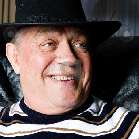 To use this stock image in your creative project, please select the size you need over to the right and click the "Add to Cart" button.
Your downloaded image will come with the Cutcaster watermark removed so don’t worry about the watermark you see on this page. Grandfather who is proud on his new cowboy hat stock photo, Older man smiling with his black cowboy hat. by Frenk and Danielle Kaufmann