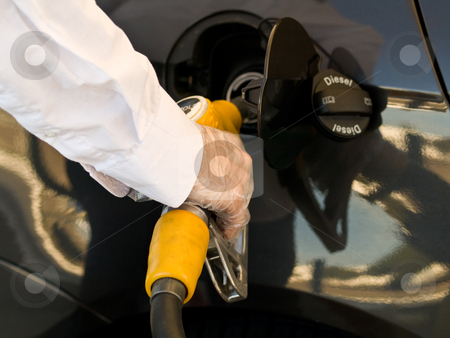 To use this stock image in your creative project, please select the size you need over to the right and click the "Add to Cart" button.
Your downloaded image will come with the Cutcaster watermark removed so don’t worry about the watermark you see on this page. Fill up tank stock photo, Man wearing protective gloves filling up his car tank with a yellow nozzle by Laurent Dambies