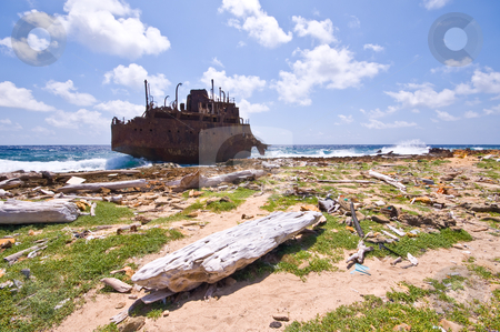 To use this stock image in your creative project, please select the size you need over to the right and click the "Add to Cart" button.
Your downloaded image will come with the Cutcaster watermark removed so don’t worry about the watermark you see on this page. Rubbish rusty wreck stock photo, Rusty wreck on little curacao with rubbish washed on the shore line by Karin Claus