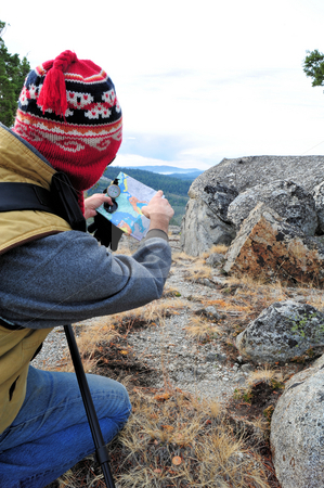 To use this stock image in your creative project, please select the size you need over to the right and click the "Add to Cart" button.
Your downloaded image will come with the Cutcaster watermark removed so don’t worry about the watermark you see on this page. Hiker Checking Map stock photo, A single male day hiker checking map with compass by Lynn Bendickson