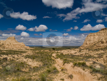 To use this stock image in your creative project, please select the size you need over to the right and click the "Add to Cart" button.
Your downloaded image will come with the Cutcaster watermark removed so don’t worry about the watermark you see on this page. Bluffs framing Blue Sky stock photo, Near Pawnee Buttes on the plains of Colorado. by John McLaird