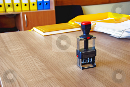 To use this stock image in your creative project, please select the size you need over to the right and click the "Add to Cart" button.
Your downloaded image will come with the Cutcaster watermark removed so don’t worry about the watermark you see on this page. Office stamp stock photo, Black stamp on wooden desk in office over files background by Julija Sapic
