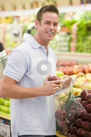 To use this stock image in your creative project, please select the size you need over to the right and click the "Add to Cart" button.
Your downloaded image will come with the Cutcaster watermark removed so don’t worry about the watermark you see on this page. Man shopping in produce section stock photo, Man shopping in produce section of supermarket by Monkey Business Images