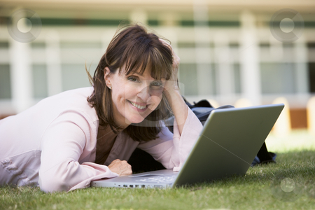 To use this stock image in your creative project, please select the size you need over to the right and click the "Add to Cart" button.
Your downloaded image will come with the Cutcaster watermark removed so don’t worry about the watermark you see on this page. Woman using laptop on campus stock photo, by Monkey Business Images