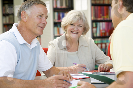 To use this stock image in your creative project, please select the size you need over to the right and click the "Add to Cart" button.
Your downloaded image will come with the Cutcaster watermark removed so don’t worry about the watermark you see on this page. Adult students working together in a library stock photo, by Monkey Business Images