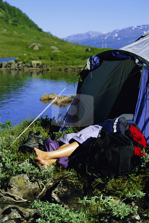 To use this stock image in your creative project, please select the size you need over to the right and click the "Add to Cart" button.
Your downloaded image will come with the Cutcaster watermark removed so don’t worry about the watermark you see on this page. Young woman asleep in tent next to lake, stock photo, by Monkey Business Images