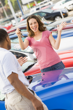 To use this stock image in your creative project, please select the size you need over to the right and click the "Add to Cart" button.
Your downloaded image will come with the Cutcaster watermark removed so don’t worry about the watermark you see on this page. Woman picking up keys to new car stock photo, Woman picking up keys to new car from lot by Monkey Business Images
