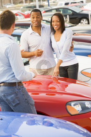 To use this stock image in your creative project, please select the size you need over to the right and click the "Add to Cart" button.
Your downloaded image will come with the Cutcaster watermark removed so don’t worry about the watermark you see on this page. Young couple discussing new car with salesman stock photo, Young couple discussing new car with salesman on lot by Monkey Business Images