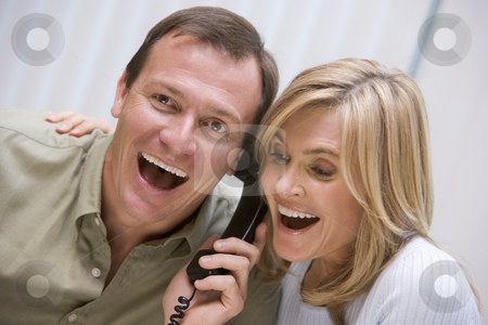 To use this stock image in your creative project, please select the size you need over to the right and click the "Add to Cart" button.
Your downloaded image will come with the Cutcaster watermark removed so don’t worry about the watermark you see on this page. Couple receiving good news over the phone stock photo, Couple receiving good news over the phone at home by Monkey Business Images