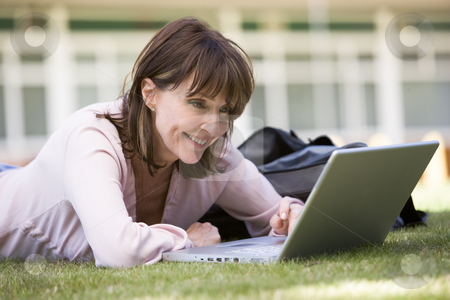 To use this stock image in your creative project, please select the size you need over to the right and click the "Add to Cart" button.
Your downloaded image will come with the Cutcaster watermark removed so don’t worry about the watermark you see on this page. Woman using laptop on campus stock photo, by Monkey Business Images