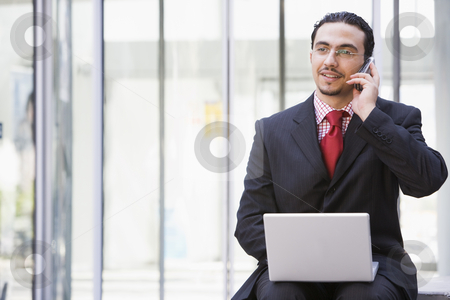 To use this stock image in your creative project, please select the size you need over to the right and click the "Add to Cart" button.
Your downloaded image will come with the Cutcaster watermark removed so don’t worry about the watermark you see on this page. Businessman using laptop and mobile phone outside stock photo, Businessman using laptop and mobile phone outside by Monkey Business Images