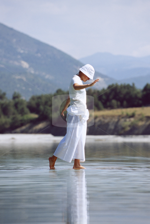 To use this stock image in your creative project, please select the size you need over to the right and click the "Add to Cart" button.
Your downloaded image will come with the Cutcaster watermark removed so don’t worry about the watermark you see on this page. Young woman walking in lake stock photo, by Monkey Business Images