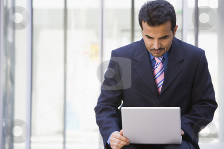 To use this stock image in your creative project, please select the size you need over to the right and click the "Add to Cart" button.
Your downloaded image will come with the Cutcaster watermark removed so don’t worry about the watermark you see on this page. Businessman using laptop outside office stock photo, Businessman using laptop outside office by Monkey Business Images