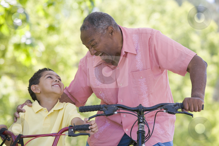 To use this stock image in your creative project, please select the size you need over to the right and click the "Add to Cart" button.
Your downloaded image will come with the Cutcaster watermark removed so don’t worry about the watermark you see on this page. Grandfather and grandson on bikes outdoors smiling stock photo, by Monkey Business Images