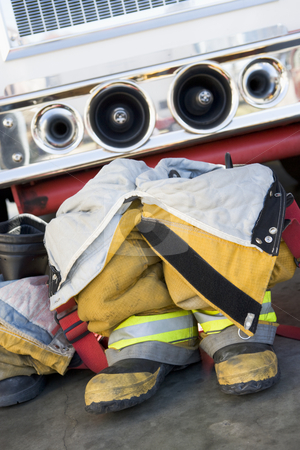 To use this stock image in your creative project, please select the size you need over to the right and click the "Add to Cart" button.
Your downloaded image will come with the Cutcaster watermark removed so don’t worry about the watermark you see on this page. Empty firefighter's boots and uniform next to fire engine stock photo, by Monkey Business Images