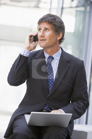 To use this stock image in your creative project, please select the size you need over to the right and click the "Add to Cart" button.
Your downloaded image will come with the Cutcaster watermark removed so don’t worry about the watermark you see on this page. Businessman sitting in office lobby with laptop using cellular p stock photo, by Monkey Business Images