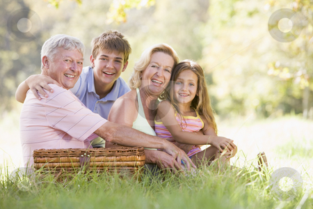 To use this stock image in your creative project, please select the size you need over to the right and click the "Add to Cart" button.
Your downloaded image will come with the Cutcaster watermark removed so don’t worry about the watermark you see on this page. Grandparents having a picnic with grandchildren stock photo, by Monkey Business Images