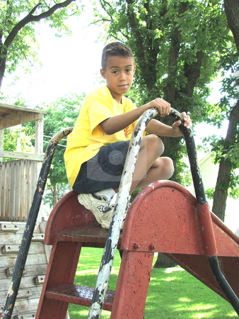 To use this stock image in your creative project, please select the size you need over to the right and click the "Add to Cart" button.
Your downloaded image will come with the Cutcaster watermark removed so don’t worry about the watermark you see on this page. Boy on playground slide stock photo, A young boy pauses at the top of an old park slide at a small playground in Chester Iowa by Dennis Thomsen