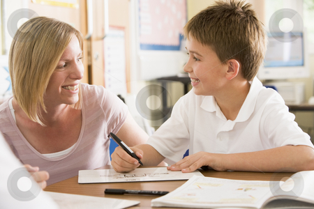 To use this stock image in your creative project, please select the size you need over to the right and click the "Add to Cart" button.
Your downloaded image will come with the Cutcaster watermark removed so don’t worry about the watermark you see on this page. A schoolboy sitting with his teacher in class stock photo, by Monkey Business Images