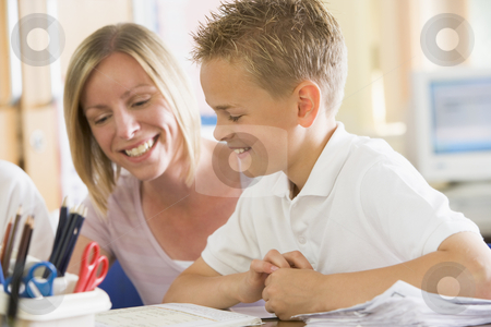 To use this stock image in your creative project, please select the size you need over to the right and click the "Add to Cart" button.
Your downloaded image will come with the Cutcaster watermark removed so don’t worry about the watermark you see on this page. A schoolboy sitting with his teacher in class stock photo, by Monkey Business Images
