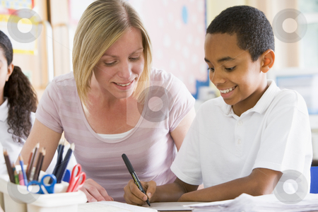 To use this stock image in your creative project, please select the size you need over to the right and click the "Add to Cart" button.
Your downloaded image will come with the Cutcaster watermark removed so don’t worry about the watermark you see on this page. A schoolboy sitting with his teacher in class stock photo, by Monkey Business Images