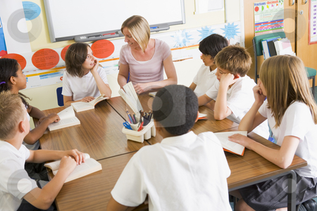 To use this stock image in your creative project, please select the size you need over to the right and click the "Add to Cart" button.
Your downloaded image will come with the Cutcaster watermark removed so don’t worry about the watermark you see on this page. Schoolchildren and their teacher reading books in class stock photo, by Monkey Business Images