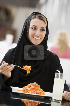 To use this stock image in your creative project, please select the size you need over to the right and click the "Add to Cart" button.
Your downloaded image will come with the Cutcaster watermark removed so don’t worry about the watermark you see on this page. A Middle Eastern woman enjoying a meal in a restaurant stock photo, by Monkey Business Images