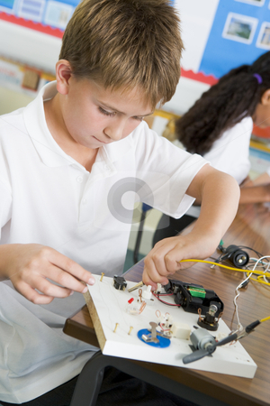 To use this stock image in your creative project, please select the size you need over to the right and click the "Add to Cart" button.
Your downloaded image will come with the Cutcaster watermark removed so don’t worry about the watermark you see on this page. A schoolboy in a science class stock photo, by Monkey Business Images