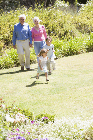 To use this stock image in your creative project, please select the size you need over to the right and click the "Add to Cart" button.
Your downloaded image will come with the Cutcaster watermark removed so don’t worry about the watermark you see on this page. Grandparents walking with grandchildren stock photo, by Monkey Business Images