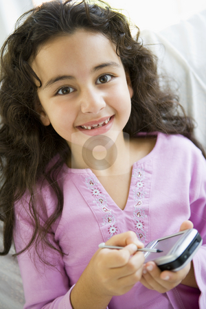 To use this stock image in your creative project, please select the size you need over to the right and click the "Add to Cart" button.
Your downloaded image will come with the Cutcaster watermark removed so don’t worry about the watermark you see on this page. A Middle Eastern girl using a PDA stock photo, by Monkey Business Images