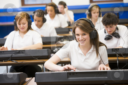To use this stock image in your creative project, please select the size you need over to the right and click the "Add to Cart" button.
Your downloaded image will come with the Cutcaster watermark removed so don’t worry about the watermark you see on this page. Schoolchildren practicing on a keyboard in music class stock photo, by Monkey Business Images
