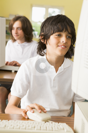 To use this stock image in your creative project, please select the size you need over to the right and click the "Add to Cart" button.
Your downloaded image will come with the Cutcaster watermark removed so don’t worry about the watermark you see on this page. Schoolboy studying in front of a school computer stock photo, by Monkey Business Images