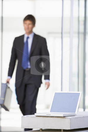 To use this stock image in your creative project, please select the size you need over to the right and click the "Add to Cart" button.
Your downloaded image will come with the Cutcaster watermark removed so don’t worry about the watermark you see on this page. Laptop sitting in office lobby with businessman walking in stock photo, by Monkey Business Images