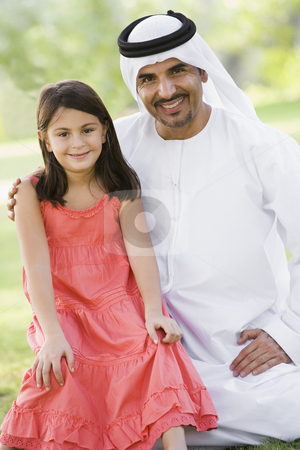 To use this stock image in your creative project, please select the size you need over to the right and click the "Add to Cart" button.
Your downloaded image will come with the Cutcaster watermark removed so don’t worry about the watermark you see on this page. A Middle Eastern man and his daughter sitting in a park stock photo, by Monkey Business Images