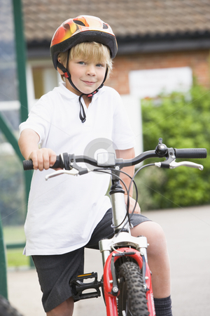To use this stock image in your creative project, please select the size you need over to the right and click the "Add to Cart" button.
Your downloaded image will come with the Cutcaster watermark removed so don’t worry about the watermark you see on this page. A young boy on a bicycle stock photo, by Monkey Business Images