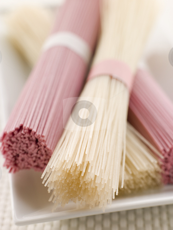 To use this stock image in your creative project, please select the size you need over to the right and click the "Add to Cart" button.
Your downloaded image will come with the Cutcaster watermark removed so don’t worry about the watermark you see on this page. Clear and Pink Dried somen Noodles stock photo, Dish of Clear and Pink Dried somen Noodles tied in bundles by Monkey Business Images