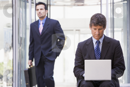 To use this stock image in your creative project, please select the size you need over to the right and click the "Add to Cart" button.
Your downloaded image will come with the Cutcaster watermark removed so don’t worry about the watermark you see on this page. Businessman using laptop computer outside stock photo, Businessman using laptop computer outside office by Monkey Business Images