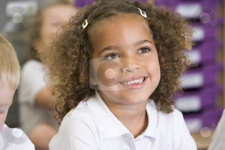 To use this stock image in your creative project, please select the size you need over to the right and click the "Add to Cart" button.
Your downloaded image will come with the Cutcaster watermark removed so don’t worry about the watermark you see on this page. Schoolgirl sitting in primary class stock photo, by Monkey Business Images