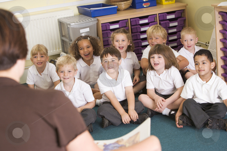 To use this stock image in your creative project, please select the size you need over to the right and click the "Add to Cart" button.
Your downloaded image will come with the Cutcaster watermark removed so don’t worry about the watermark you see on this page. A teacher reads to schoolchildren in a primary class stock photo, by Monkey Business Images