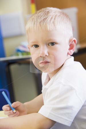 To use this stock image in your creative project, please select the size you need over to the right and click the "Add to Cart" button.
Your downloaded image will come with the Cutcaster watermark removed so don’t worry about the watermark you see on this page. A schoolboy sitting in a primary class stock photo, by Monkey Business Images