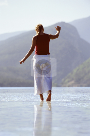 To use this stock image in your creative project, please select the size you need over to the right and click the "Add to Cart" button.
Your downloaded image will come with the Cutcaster watermark removed so don’t worry about the watermark you see on this page. Young woman wading in lake stock photo, by Monkey Business Images