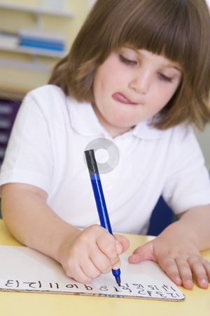 To use this stock image in your creative project, please select the size you need over to the right and click the "Add to Cart" button.
Your downloaded image will come with the Cutcaster watermark removed so don’t worry about the watermark you see on this page. Girl learning to write numbers in primary class stock photo, by Monkey Business Images
